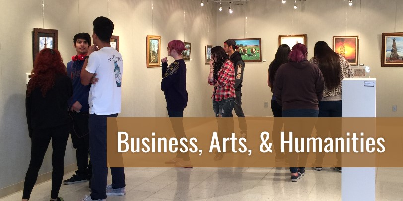 Business, Arts and Humanities - Students in a museum viewing and discussing art.